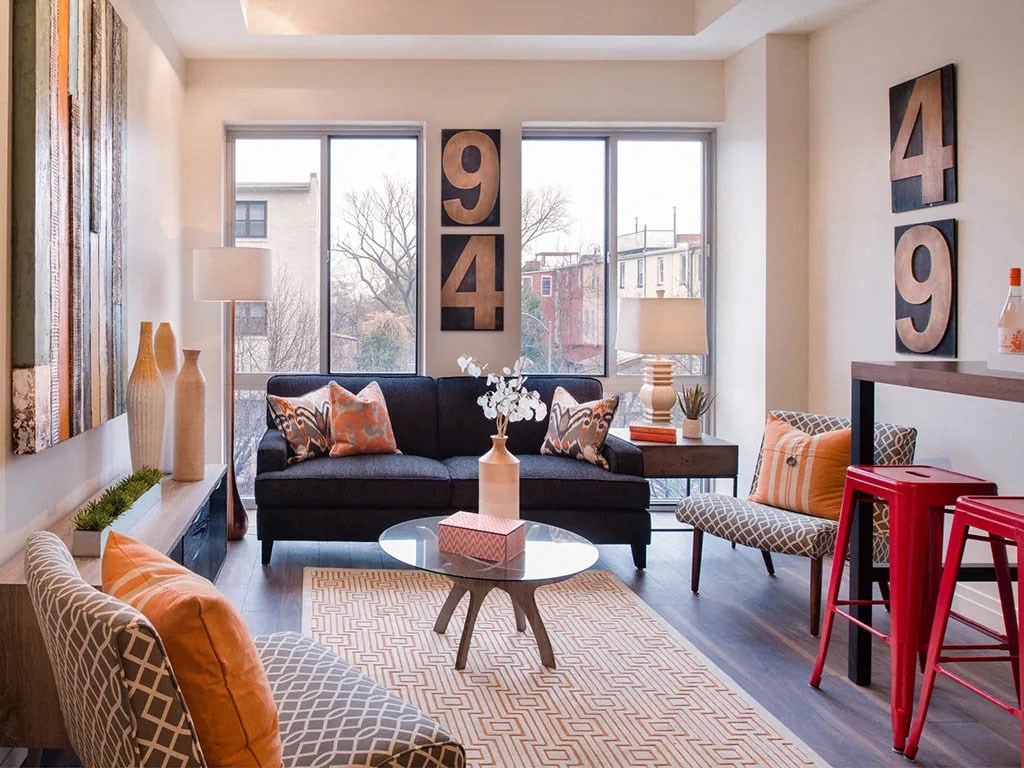 a living room with a couch and chairs and a table