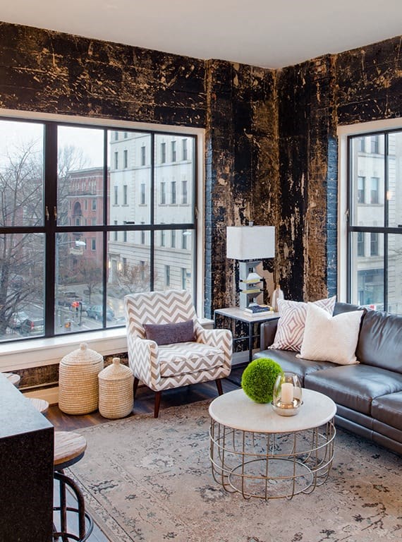 a living room with a leather couch and a large window