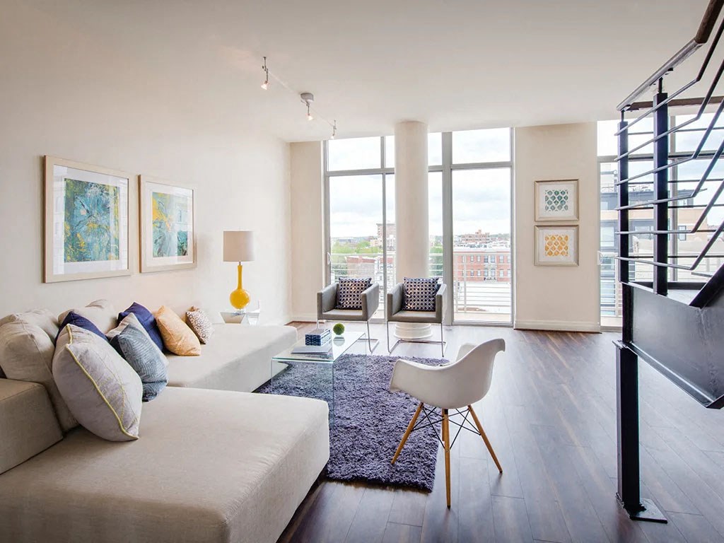 a living room with a white couch and a tv