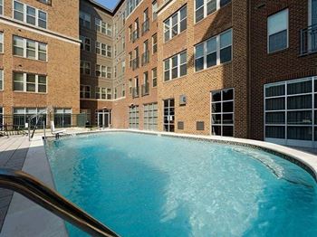 a large swimming pool in front of a building