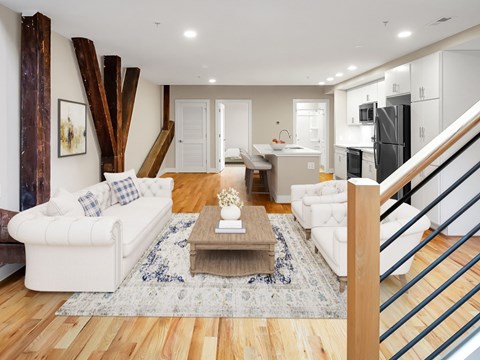A living room with a white couch and a coffee table.