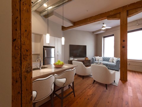 A kitchen with a dining table and chairs.