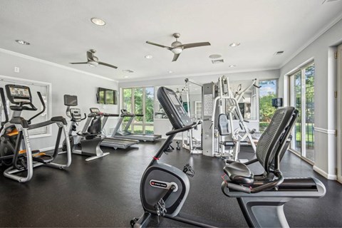 A spacious home gym with a variety of exercise equipment.