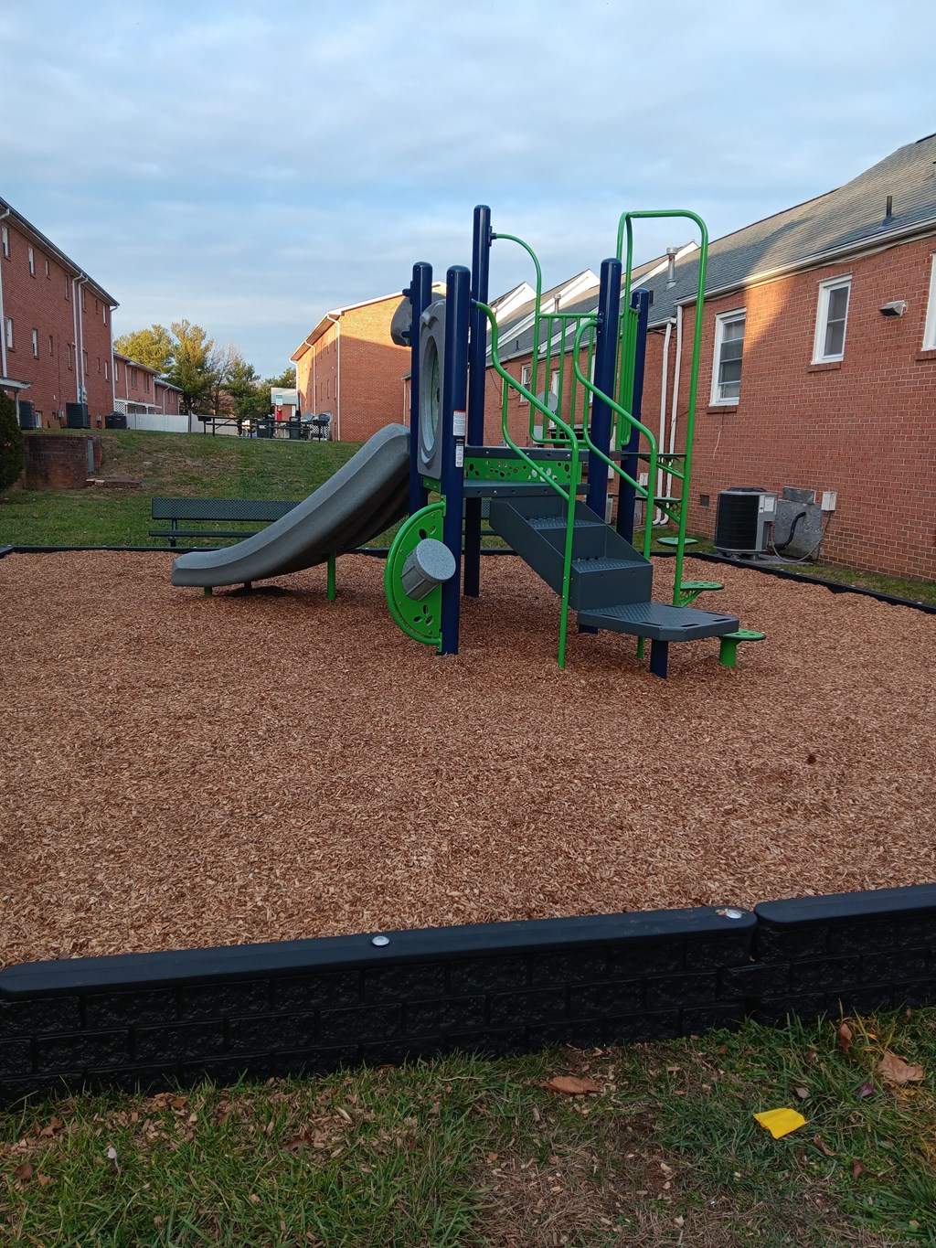 a playground with a slide in a courtyard