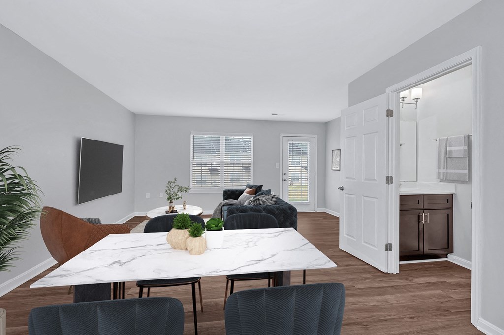 a dining area with a white marble table and blue chairs