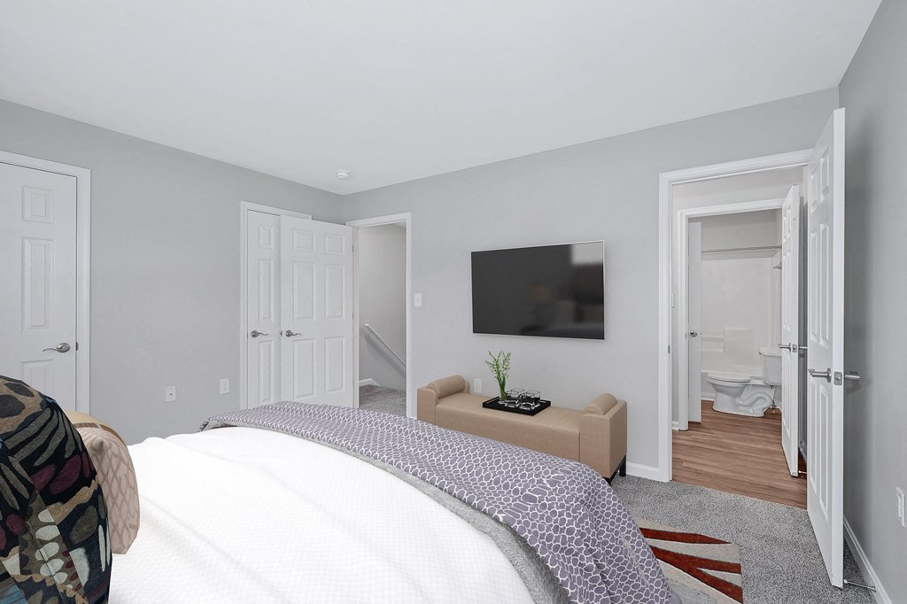 a bedroom with a tv on the wall