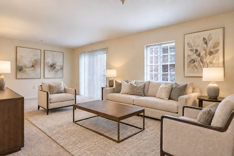 A living room with a couch, chairs, and a coffee table.