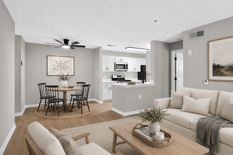 A living room with a dining table and chairs.