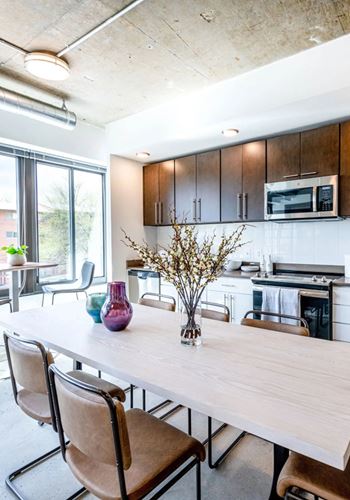 a kitchen and dining area in a 555 waverly unit