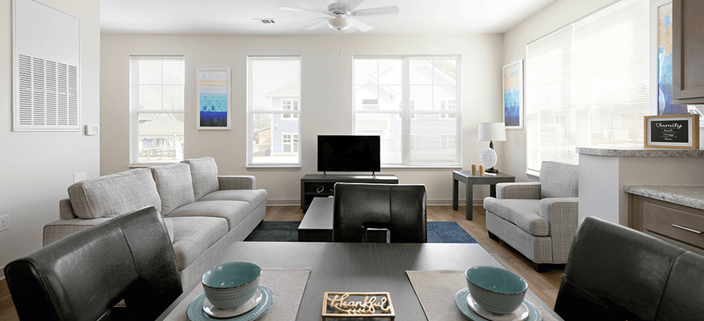 a living room with couches and chairs and a table