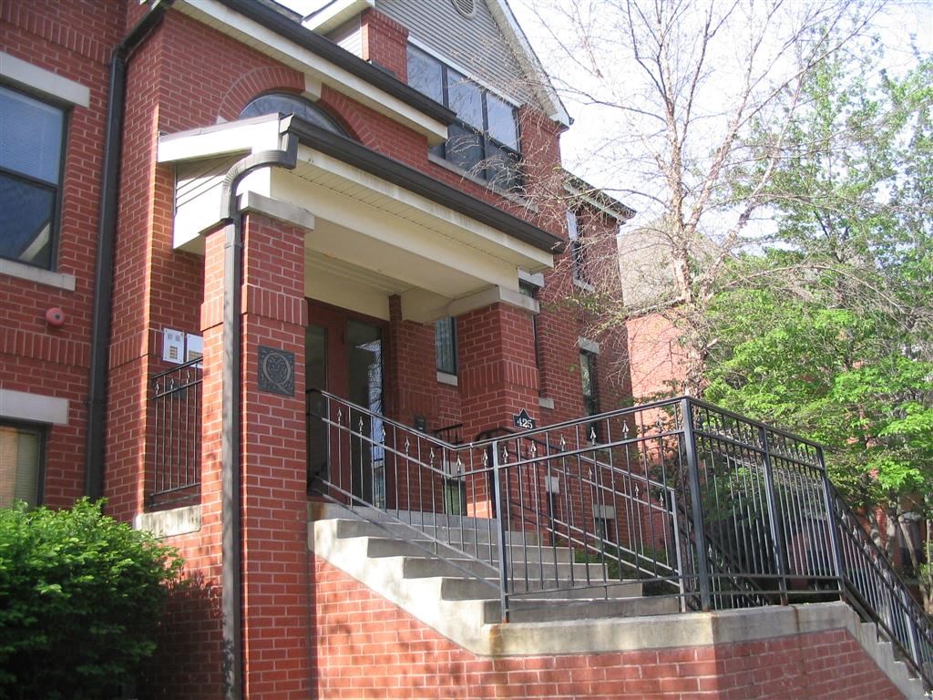 a large brick building with a staircase in front of it