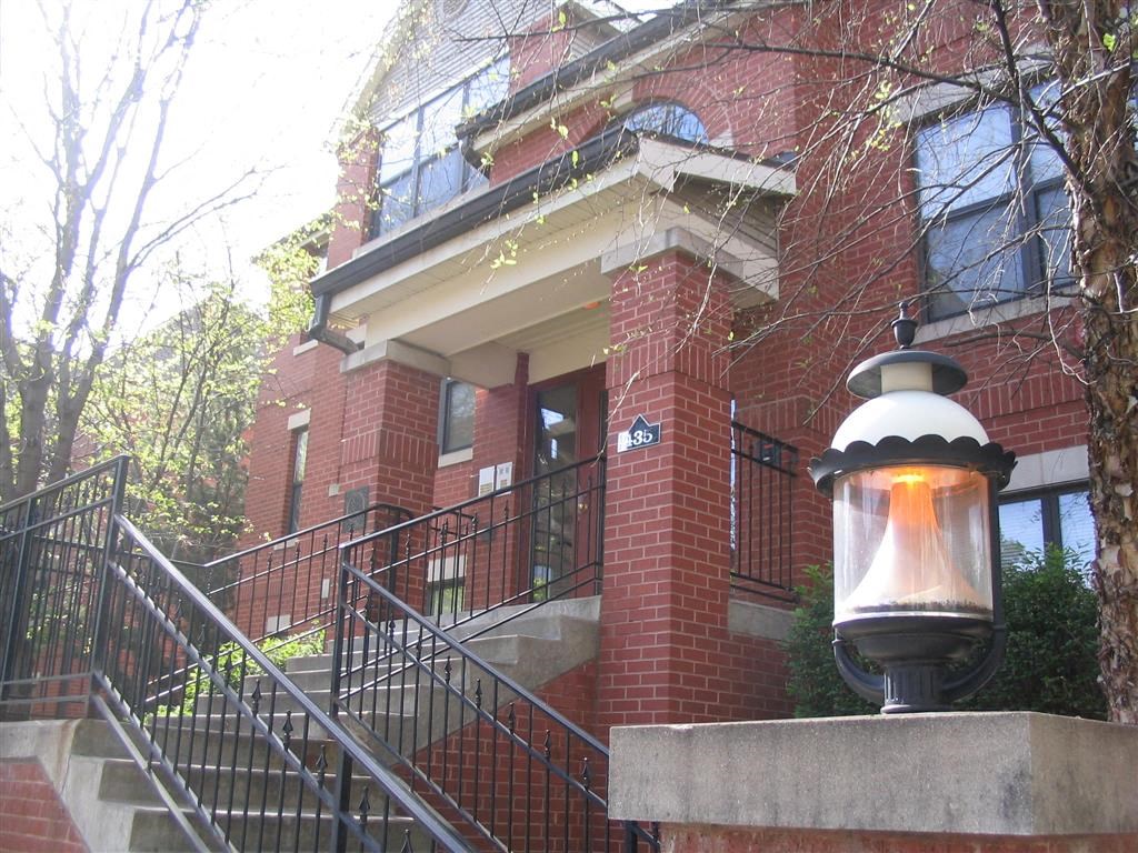 a lamp post in front of a brick building