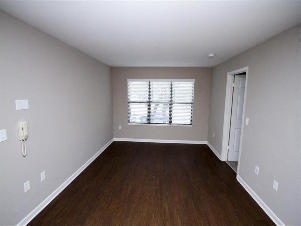 an empty room with a window and a door