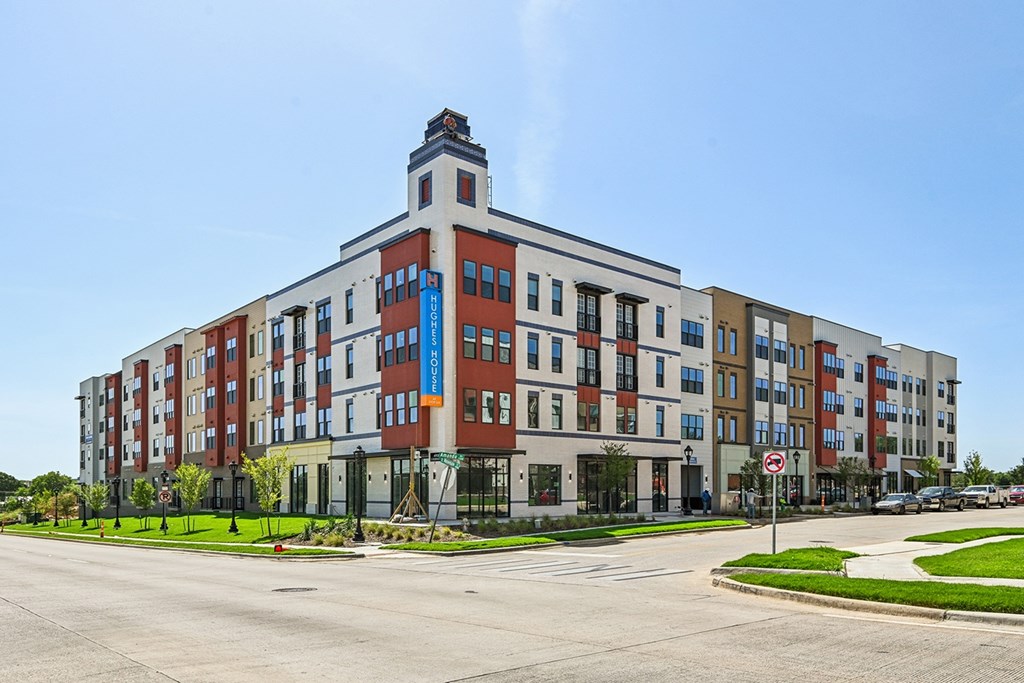 A large multi-story building with a clock tower on the top.