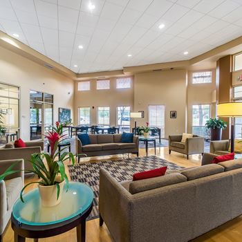 a lobby with couches and chairs and a table