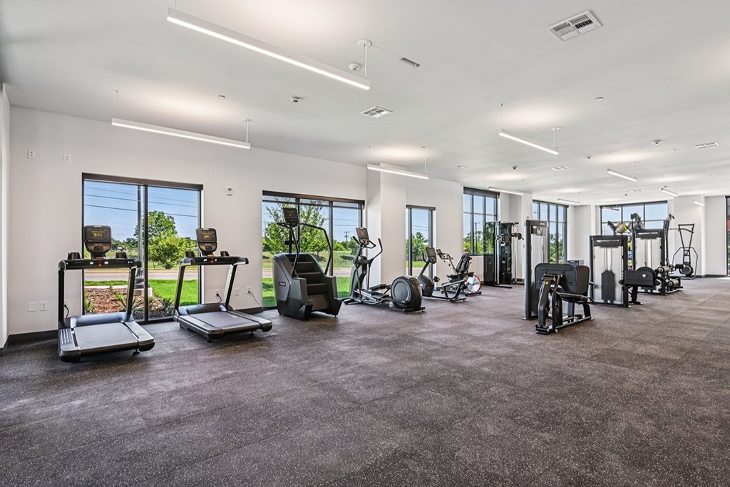 A spacious gym with treadmills, elliptical machines, and other exercise equipment.