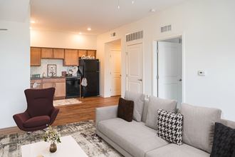 Staged apartment living room and kitchen-Legacy Pointe at Poindexter, Columbus, OH