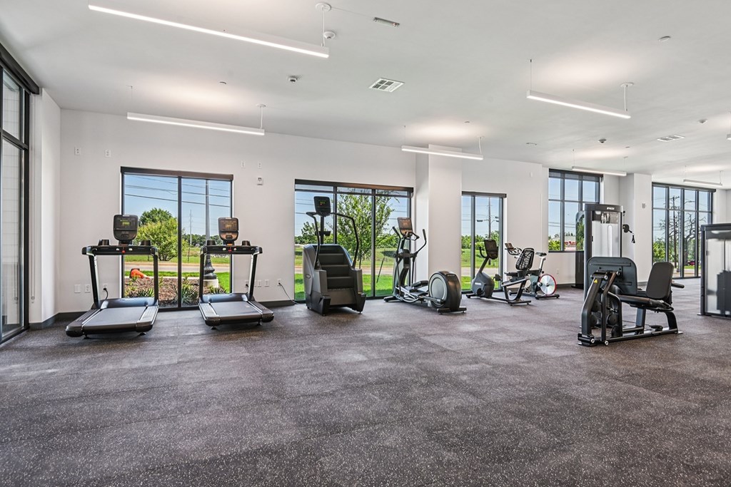 A spacious gym with treadmills, elliptical machines, and other exercise equipment.