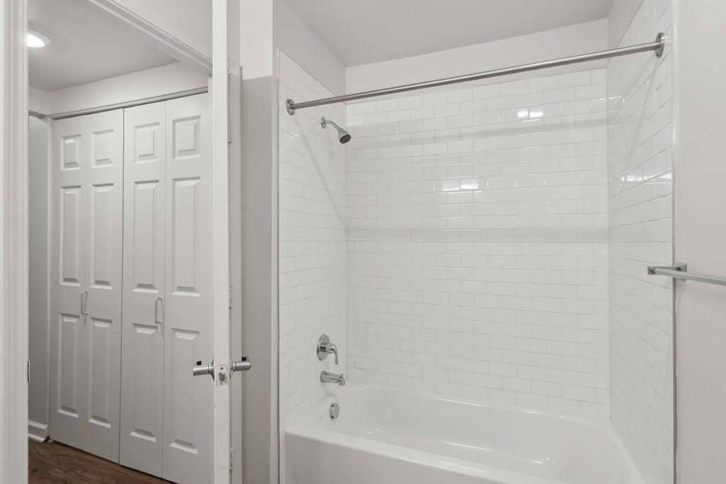 A white bathroom with a walk in shower.