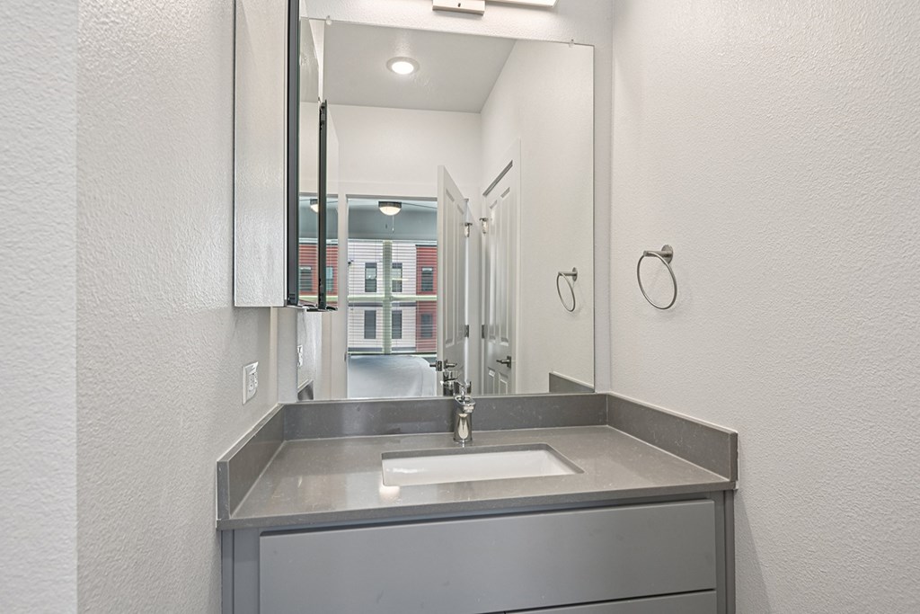 A bathroom sink with a mirror above it.