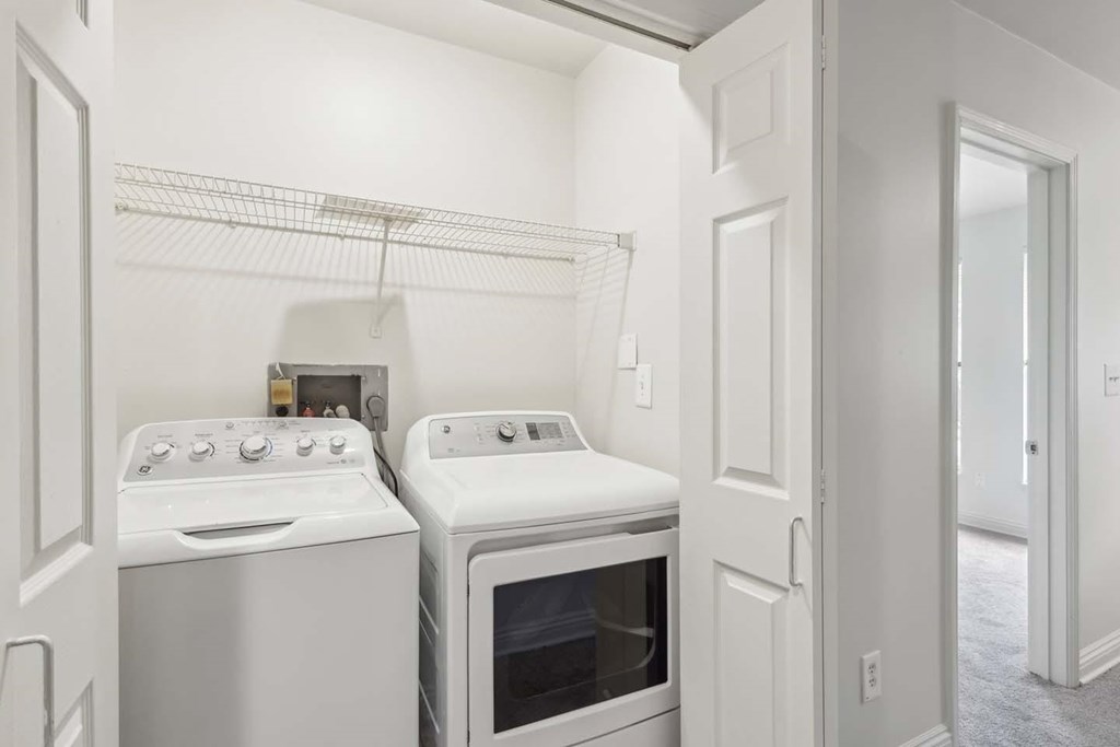 A white oven and dishwasher in a small kitchen.