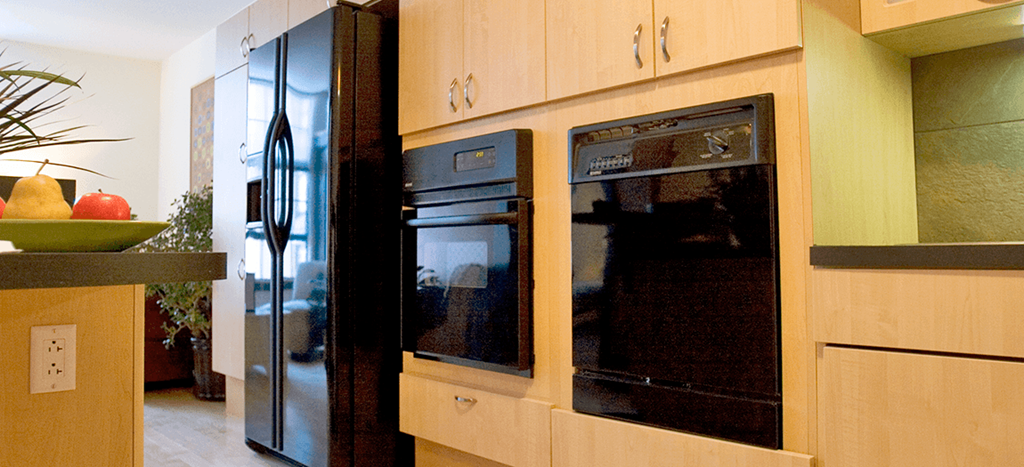 a kitchen with two ovens and a refrigerator