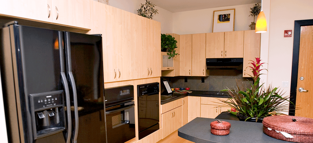 a kitchen with black appliances and wooden cabinets
