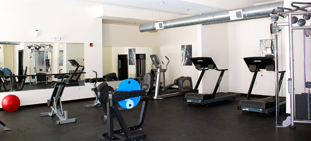 6 North apartments workout room with various exercise equipment in a gym
