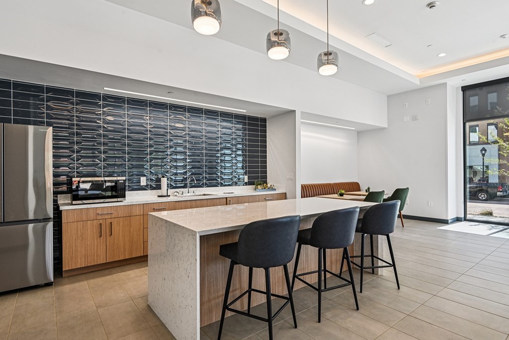 A modern kitchen with a large island and bar stools.
