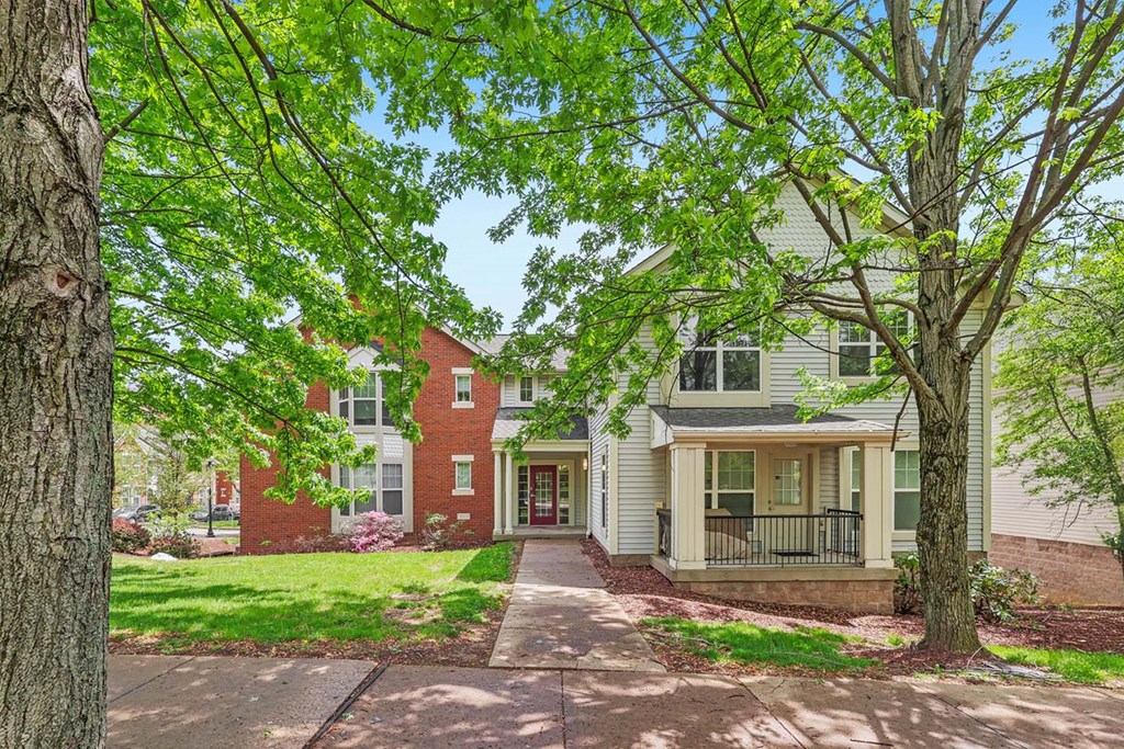 A tree is in front of a house.