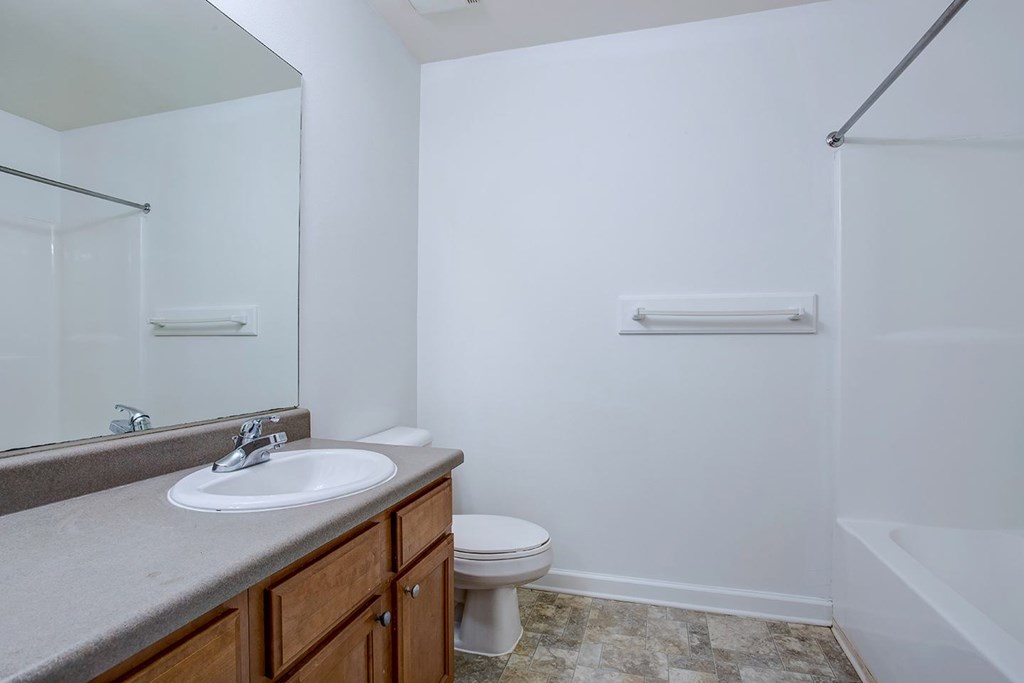 A bathroom with a sink, toilet, and bathtub.
