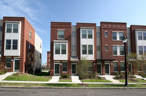 a row of brick apartment buildings on a city street