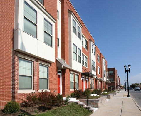 a large brick building with a sidewalk in front of it