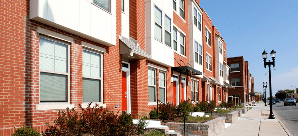 a row of brick apartment buildings on a city street