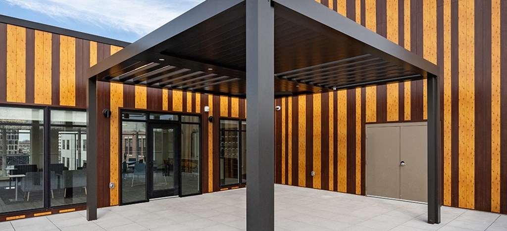 Rooftop terrace with glass doors and awning