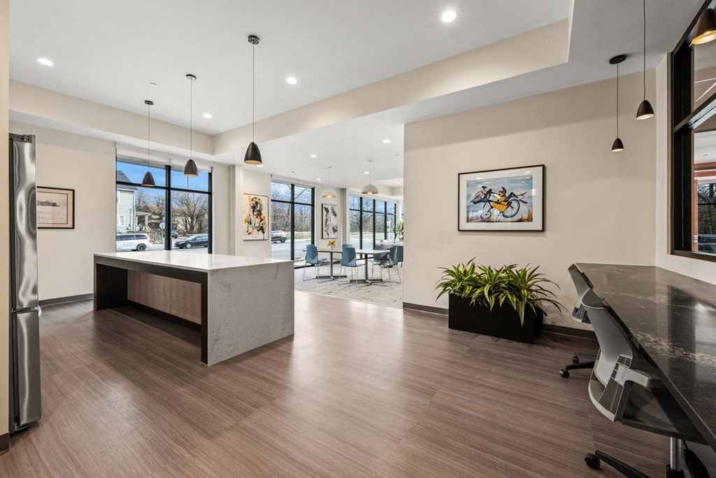 A modern office space with a reception desk and a long table.