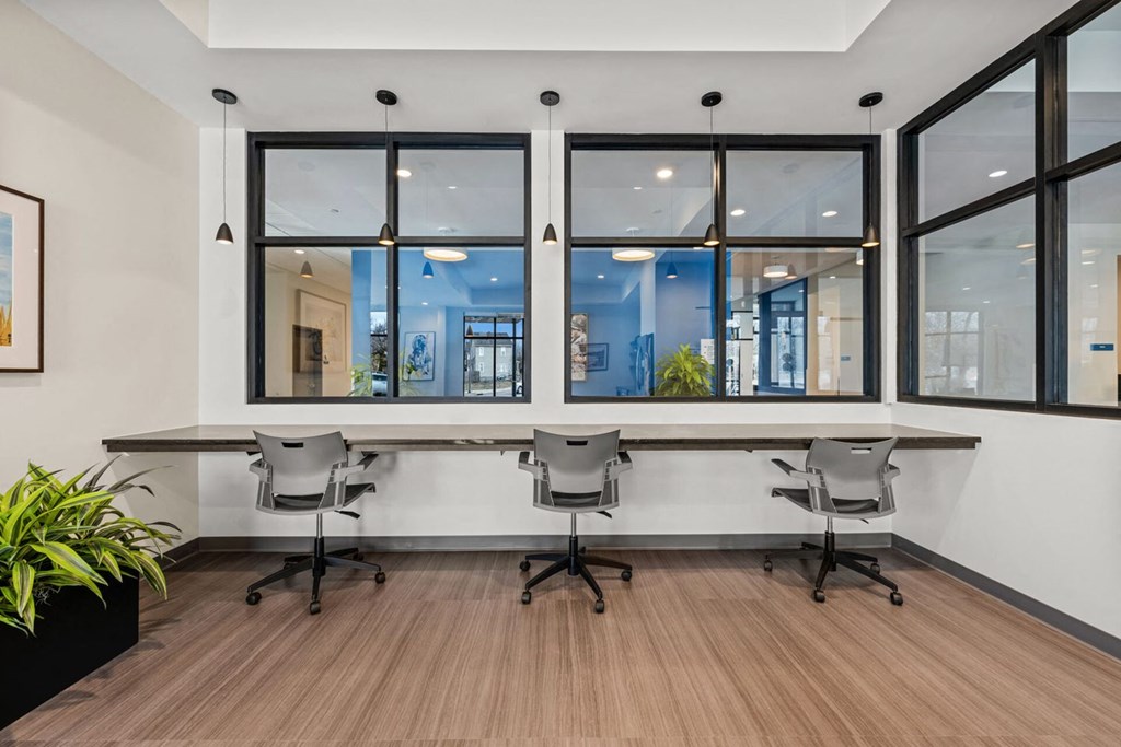 A conference room with a long table and chairs.