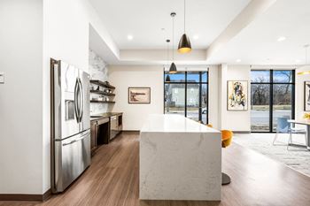A modern kitchen with a large island and stainless steel appliances.
