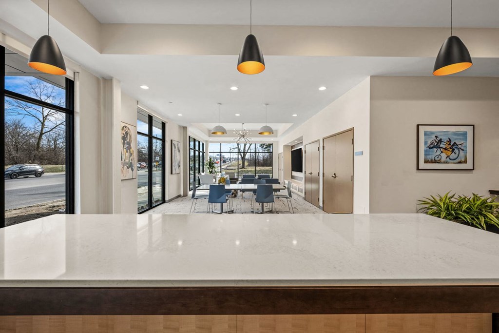 A modern dining area with a long table and chairs.