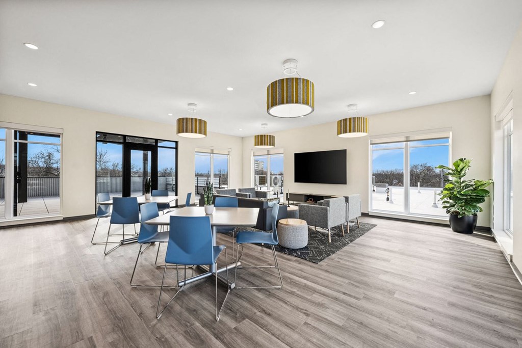 A modern living room with a dining area and a television.