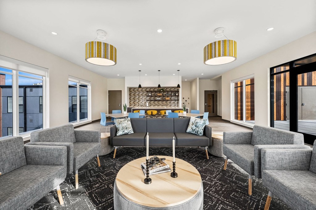 A living room with grey couches and a wooden coffee table.