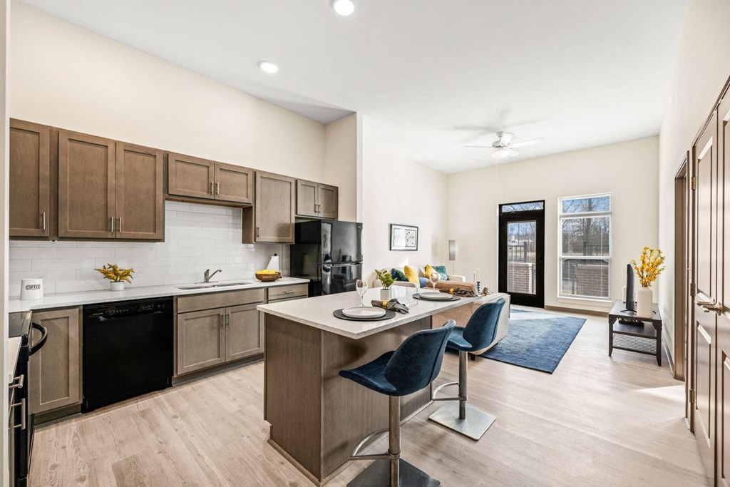 A kitchen with a dining table and chairs.