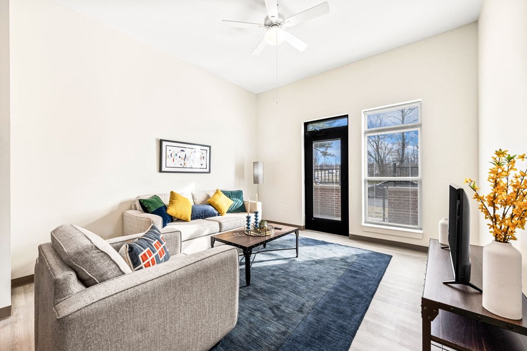 A living room with a grey couch and a coffee table.