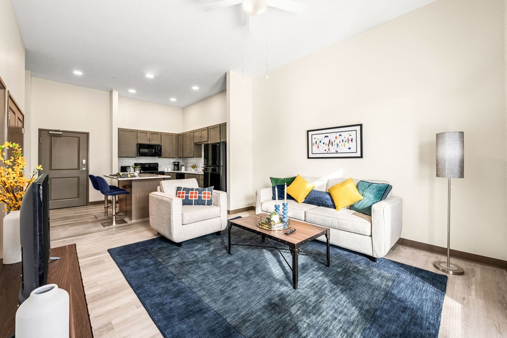 A living room with a white couch and a coffee table.