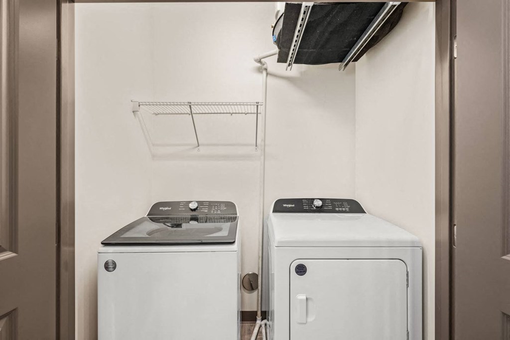 A small laundry room with a washer and dryer.