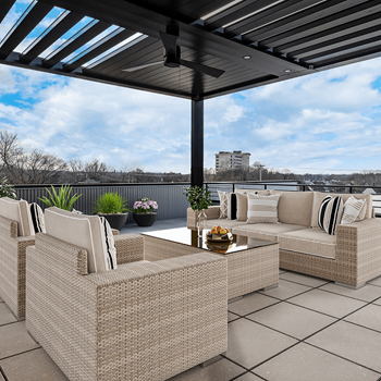 a patio with wicker furniture and a pergola on a roof at Aura at Innovation Square