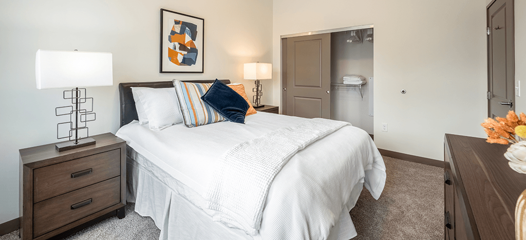 a bedroom with a white bed and a closet