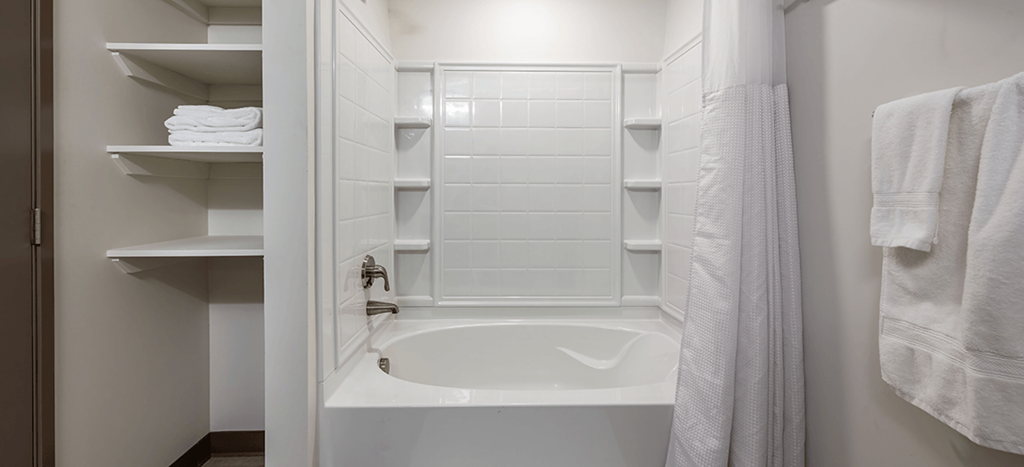a small bathroom with a shower and a bath tub