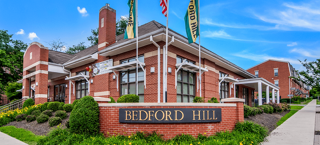 Bedford Hill Apartments leasing office a brick building with a sign