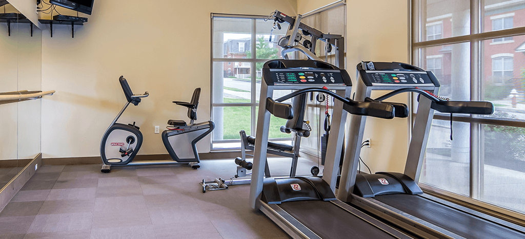 a gym with treadmills and other exercise equipment